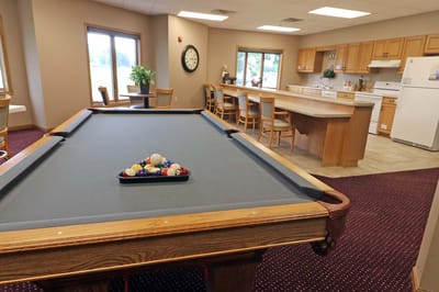 Common area with pool table and kitchen