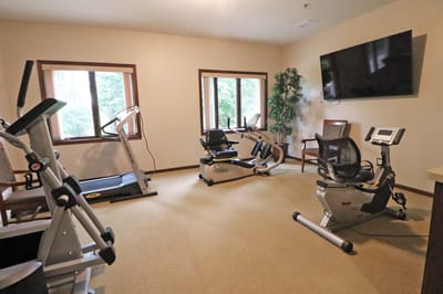 Fitness room with exercise equipment and windows