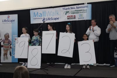 Children holding numbers at a charity event.
