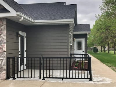 Exterior view of a facility entrance with railings.