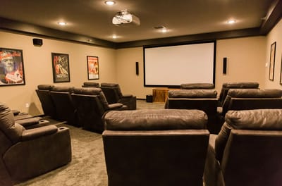Comfortable movie theater seating in a common area.