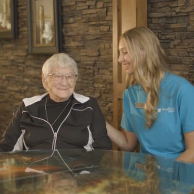 Staff member interacting with an elderly resident.