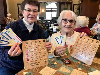 Two residents enjoying a Bingo game together.