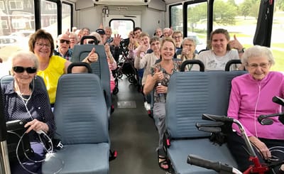Residents enjoying a trip on a facility bus.