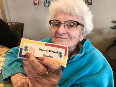 Senior resident holding StoneyBrook Bucks