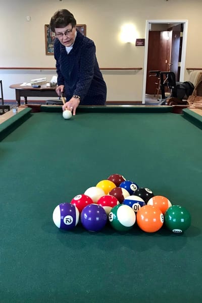 Resident playing billiards in the activity room