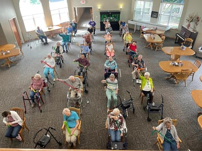 Residents participating in a seated exercise class.