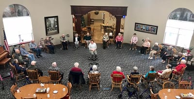 Residents and staff engaged in an activity in a common area