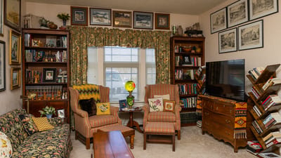 Cozy common area with bookshelves and comfortable seating.