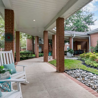 Welcoming outdoor pathway with seating and gardens.