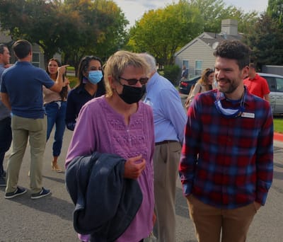 Residents and staff interacting outdoors at an event.