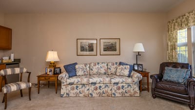 Cozy sitting area with floral couch and artwork