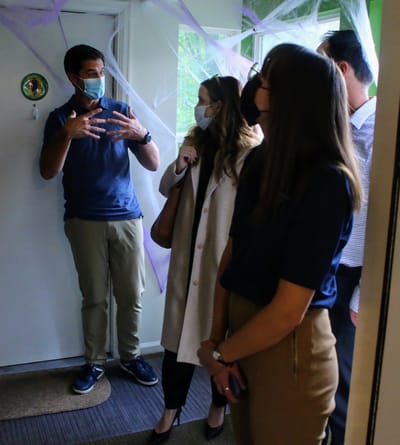 Staff and visitors engaged in conversation indoors