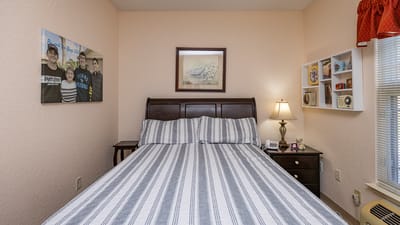 Cozy resident bedroom with a neatly made bed.