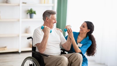 A senior exercising with a staff member