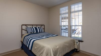 Cozy resident room with a bed and windows