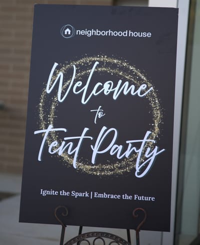 Sign welcoming guests to a tent party.