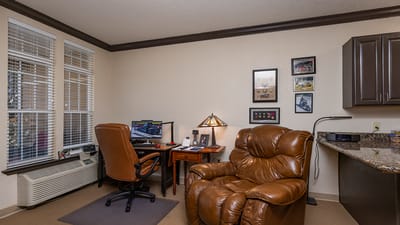 Cozy corner of a resident's room with chairs and desk