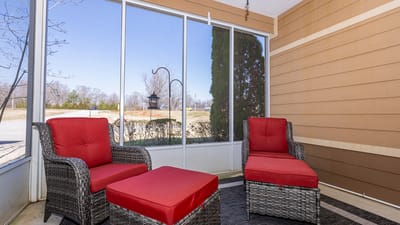 Cozy outdoor seating area with red cushions.