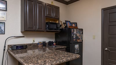 Interior kitchen area with a counter and refrigerator