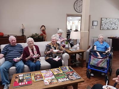 Residents enjoying snacks in a common area.