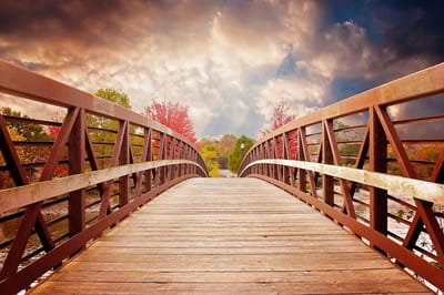 Wooden bridge in a scenic outdoor setting.