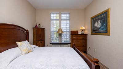 Cozy bedroom with wooden furniture and natural light.