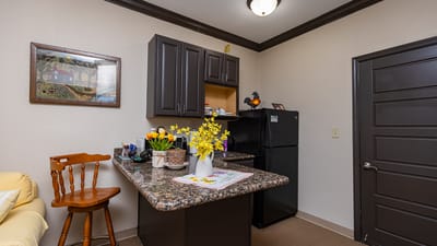 Cozy kitchenette in a resident room with yellow flowers.