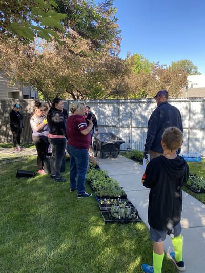 Residents and staff gardening outdoors.