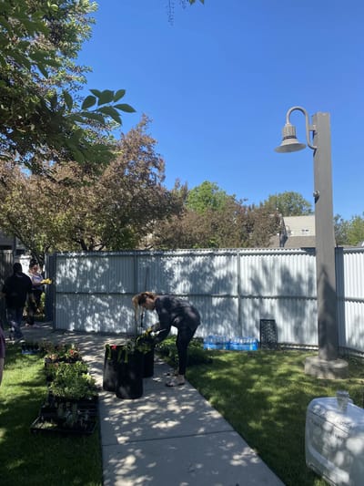 Resident engaging in gardening activity outdoors.