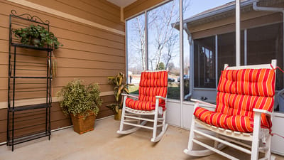 Porch area with rocking chairs and potted plants
