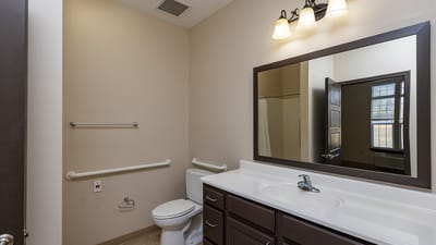 Brightly lit bathroom with modern fixtures.
