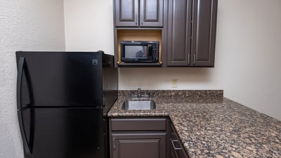 Kitchen area with refrigerator and microwave