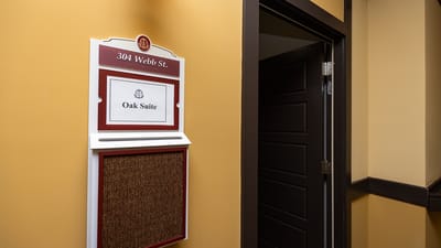 Hallway with a room sign for Oak Suite