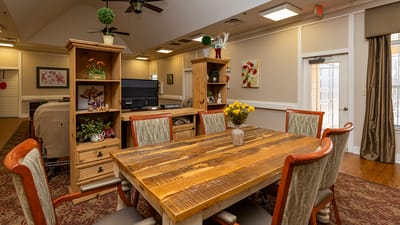 Interior view of a common area with wooden table and decor.