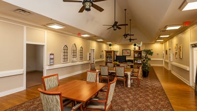 Interior view of a common area with tables and seating.