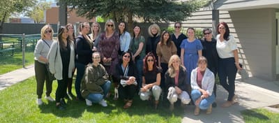 Group of staff members in a garden area.