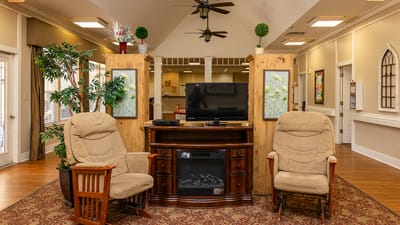 Cozy common area with rocking chairs and TV.