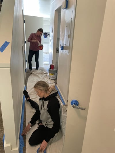Volunteers painting a hallway in the facility.