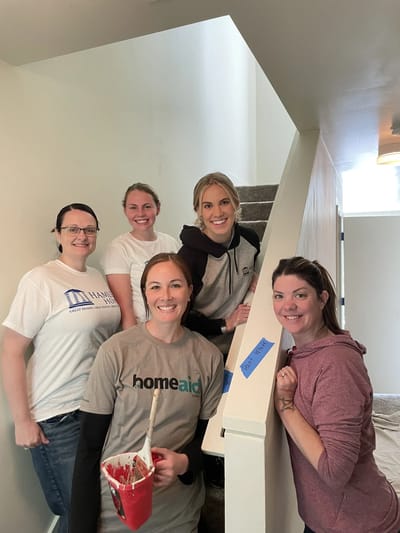 Volunteers and staff assisting with interior painting.