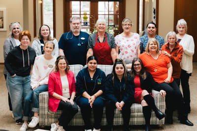 Staff and residents smiling in a common area