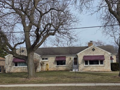 Exterior view of a single-story stone building.