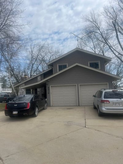 Exterior view of a building with parked cars.