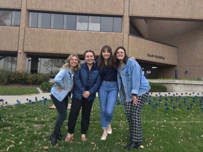 Group of four women posing outside the building