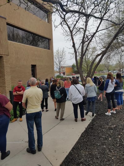 Crowd of people outside the facility building