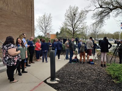 Group of people gathered outside, possibly for an event.
