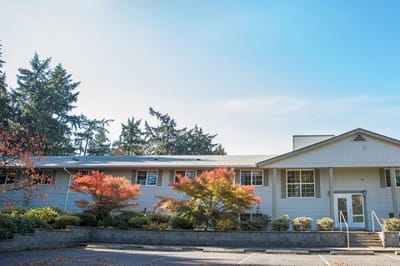 Exterior view of the facility with trees and landscaping.