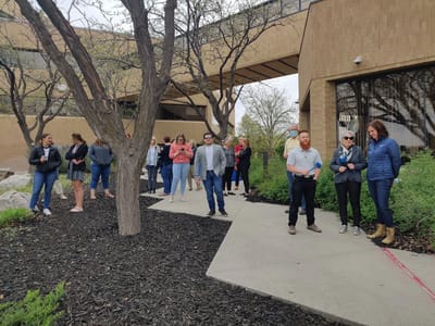 A group of people gathered outdoors at a facility