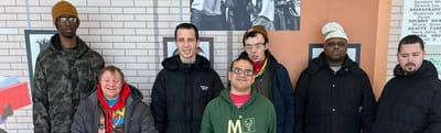 Group of residents smiling in the common area.