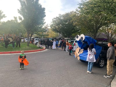 Halloween celebration with residents and staff in costumes.